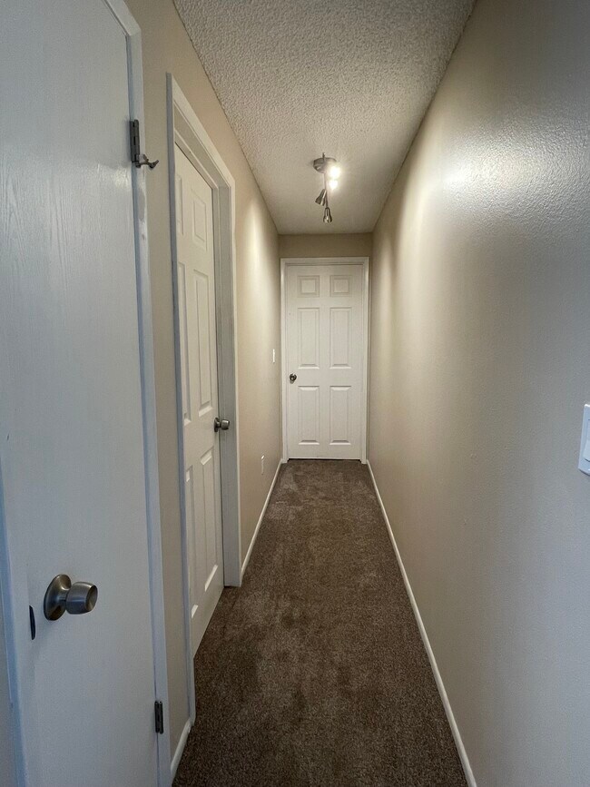 Hallway with new lighting and storage closet - 46398 Max Harder Rd N