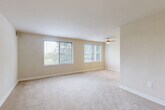 Located at 5309 Riverdale Rd in Riverdale Park, Maryland, this single-floor, one-bedroom, one-bathroom residence offers a well-organized and efficiently designed layout. The open living and dining area is a standout feature, bathed in natural light from a pair of large windows that offer pleasant views of the surrounding greenery. Soft wall-to-wall carpeting and warm neutral tones create a comfortable, inviting ambiance throughout, while a ceiling fan adds both function and a finishing touch to the living space. The kitchen features rich wood-toned cabinetry and tile flooring, providing a practical and warm cooking environment. The generously sized bedroom includes a window with outdoor views, carpeted flooring, and access to multiple closets — four closets total are distributed throughout the unit, offering excellent storage capacity. The bathroom is clean and classic, appointed with a full soaking tub and shower combination set within floor-to-ceiling white subway tile. A hallway connects the rooms cohesively, contributing to the smooth flow of the floorplan. The unit's neutral palette and consistent finishes throughout give it a clean, move-in-ready character well-suited for a variety of lifestyles.