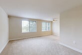 Located at 5309 Riverdale Rd in Riverdale Park, Maryland, this single-floor, one-bedroom, one-bathroom residence offers a well-organized and efficiently designed layout. The open living and dining area is a standout feature, bathed in natural light from a pair of large windows that offer pleasant views of the surrounding greenery. Soft wall-to-wall carpeting and warm neutral tones create a comfortable, inviting ambiance throughout, while a ceiling fan adds both function and a finishing touch to the living space. The kitchen features rich wood-toned cabinetry and tile flooring, providing a practical and warm cooking environment. The generously sized bedroom includes a window with outdoor views, carpeted flooring, and access to multiple closets — four closets total are distributed throughout the unit, offering excellent storage capacity. The bathroom is clean and classic, appointed with a full soaking tub and shower combination set within floor-to-ceiling white subway tile. A hallway connects the rooms cohesively, contributing to the smooth flow of the floorplan. The unit's neutral palette and consistent finishes throughout give it a clean, move-in-ready character well-suited for a variety of lifestyles.