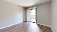 Located at 600 Front St in the heart of San Diego, CA, this one-bedroom, one-bathroom apartment offers a well-organized and efficiently designed layout across a single floor. Wood-style flooring runs throughout the unit, lending warmth and continuity to every room.

The combined kitchen and living area forms the heart of the unit. The kitchen is outfitted with crisp white cabinetry, light countertops, and a full suite of white Whirlpool appliances, including an electric range, over-the-range microwave, dishwasher, and refrigerator. A ceiling fan overhead adds comfort to the living space, which opens via a sliding glass door to a private balcony, bringing in natural light and outdoor views of the surrounding San Diego cityscape.

The bedroom is a quiet, well-lit space featuring a window with views of greenery and neighboring architecture, along with a wall-mounted HVAC unit for individual climate control. A dedicated closet provides convenient storage.

The bathroom is clean and functional, finished in white with wood-style flooring carried throughout. It includes a shower-tub combination, a toilet, and a vanity with cabinet storage.

Neutral-toned walls in warm greige complement the light-filled interiors throughout, creating a cohesive and move-in-ready living environment in one of San Diego's most accessible downtown locations.