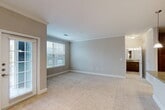 Located at 4400 College Park Dr in Conroe, TX, this well-appointed one-bedroom, one-bathroom residence offers a thoughtfully designed single-floor layout. The open-concept living area seamlessly connects the living room, dining room, and kitchen, creating a spacious and functional gathering space. The kitchen is a standout feature, showcasing rich dark cabinetry, granite countertops, a subway tile backsplash, and a full suite of stainless steel appliances including a refrigerator, electric range, microwave, and dishwasher, complemented by wood-look flooring.

The bedroom is generously sized, finished with plush carpet, crown molding, a ceiling fan, and ample natural light. It connects directly to two closets, including a walk-in closet with built-in shelving and hanging rods for organized storage. The bathroom features a granite-topped vanity with dark wood cabinetry, a tub-shower combination, and wood-look flooring. Neutral tones and crown molding throughout lend a clean, cohesive aesthetic. Additional conveniences include an in-unit laundry area and a private patio, rounding out this comfortable and practical living space.
