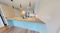 Located at 855 N. Broadway, Unit 401 in Denver, CO, this modern condominium offers 860 square feet of thoughtfully designed living space across 2 bedrooms and 3 bathrooms. The open-concept living area features light hardwood flooring and expansive floor-to-ceiling windows that flood the space with natural light and frame impressive views of the Denver skyline and surrounding neighborhood. A sliding glass door provides access to an outdoor balcony. The kitchen is outfitted with shaker-style cabinetry, a marble-inspired tile backsplash, stainless steel appliances including a French door refrigerator and built-in microwave, and a large peninsula with pendant lighting and an undermount sink—ideal for both cooking and entertaining. In-unit stacked washer and dryer add everyday convenience. The primary bedroom spans 160 square feet and connects to a spa-inspired en-suite bathroom featuring a double-sink vanity with gray quartz countertops, matte black hardware, large-format tile flooring, and a glass-enclosed marble-tiled shower. The second bedroom features warm hardwood flooring and an architectural concrete column accent. Additional bathrooms mirror the same refined aesthetic. A dedicated closet completes this polished urban retreat.