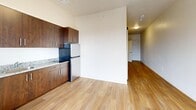 This efficient one-bedroom, one-bathroom residence in Salt Lake City, UT, offers a thoughtfully organized layout across a single floor. Light wood-style flooring runs throughout, lending warmth and visual continuity to the entire space.

The main living and kitchen area serves as the heart of the unit, featuring rich dark-wood cabinetry, granite countertops, a tile backsplash, and stainless steel appliances including a full-size refrigerator. A glass-paneled door floods the space with natural light and opens onto a private balcony, offering outdoor views of the surrounding neighborhood.

A standout design element is the sleek sliding barn door with black hardware, which adds a modern, industrial touch to the interior while efficiently separating spaces. The hallway connects the main living area to the bedroom, bathroom, and multiple closets, providing ample storage throughout.

The bathroom features a wall-mounted sink and clean, neutral finishes, with paneled white doors completing the crisp aesthetic. The bedroom is an intimate, cozy space with the same consistent flooring and neutral wall tones.

The textured ceiling in portions of the unit and clean white walls throughout create a bright, move-in-ready atmosphere. With three closets and a well-planned layout, this unit maximizes functionality and practicality within its compact footprint.