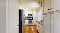 Located on West End Avenue in Nashville, Tennessee, this well-designed single-floor residence offers three bedrooms, four bathrooms, and a thoughtful layout that maximizes comfort and functionality. Rich hardwood flooring flows consistently throughout the home, creating a warm and cohesive aesthetic in every room.

The living room is generously proportioned, featuring crown molding, a ceiling fan, and floor-to-ceiling vertical blinds that frame sliding glass doors and invite abundant natural light. The open, airy feel of the space makes it ideal for both everyday living and entertaining.

The kitchen is efficiently arranged with white cabinetry, dark granite countertops, a mosaic tile backsplash, and a full suite of stainless steel appliances including a refrigerator, stove, and built-in microwave. Track lighting adds a functional, modern touch overhead.

The three bedrooms are bright and well-sized, with the primary bedroom offering notable square footage. Each room includes ceiling fans and windows with natural light. The bathrooms are finished with white vanity cabinetry, marble-style countertops, and ornate framed mirrors that lend a classic, refined character. A dedicated closet adds practical storage to round out this well-appointed Nashville residence.