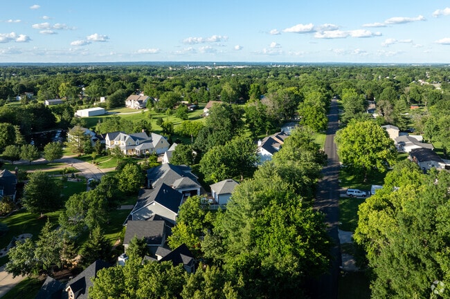 Homes in St. Peters often sit beneath a large canopy of mature trees.