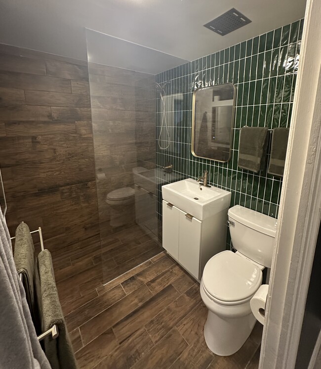 Modern bath with all new tile, lighting, and Delta fixtures. Walk in shower. - 631 Ofarrell St