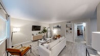 Located at 600 Nottingham Oaks Trail in Houston's 77079 corridor, this single-story residence presents a cohesive, modern aesthetic throughout its well-organized floor plan. The living room serves as the heart of the home, featuring light wood-look flooring, soft neutral walls, and generous natural light admitted through large windows with clean white blinds. Built-in shelving adds functional character to the space, which flows naturally into a dedicated dining area — a cozy yet defined room with chair-rail detailing and direct access to the kitchen.

The galley-style kitchen is efficiently designed with gray shaker cabinetry, white quartz countertops, a classic subway tile backsplash, stainless steel appliances including a dishwasher, range, and refrigerator, and a window that draws in natural light.

The bedrooms are comfortably scaled, each featuring the same wood-look flooring, natural light from well-positioned windows, and ceiling fixtures. The bathrooms showcase a standout design element: large-format marble-look tile surrounds the tub-shower combinations, accented by a decorative mosaic border, creating a clean and polished finish throughout.