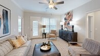 Located at 2655 Andover Hill Way in Knoxville, TN, this well-appointed 2-bedroom, 2-bathroom single-floor residence offers a thoughtfully designed layout with modern finishes throughout. Light-toned hardwood-style flooring flows continuously across the living areas, complementing the neutral color palette and crown molding details that lend a polished, cohesive aesthetic.

The heart of the home is an open-concept kitchen, dining, and living area. The kitchen features crisp white cabinetry, granite countertops, a shiplap-paneled island with seating for several, a subway tile backsplash, and stainless steel appliances — all illuminated by stylish pendant lighting and recessed fixtures. A dedicated dining area sits adjacent, providing a comfortable space for everyday meals.

The primary bedroom is a well-sized retreat with warm neutral tones and hardwood-style flooring. Both bathrooms are finished with granite vanities, white cabinetry, and tile flooring, with at least one featuring a glass-enclosed walk-in shower. The walk-in closet includes built-in wire shelving for organized storage. A dedicated laundry room houses full-sized washer and dryer units. The second bedroom benefits from a large window allowing natural light to brighten the space. Crown molding, recessed lighting, and quality finishes unify this move-in-ready home.