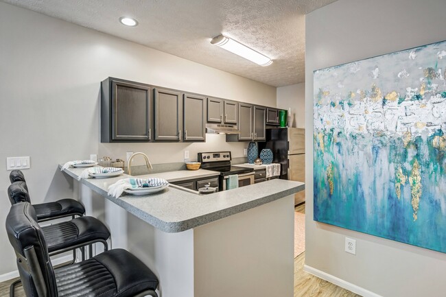 Kitchen with Breakfast Bar - The Commons at Canal Winchester Apartments