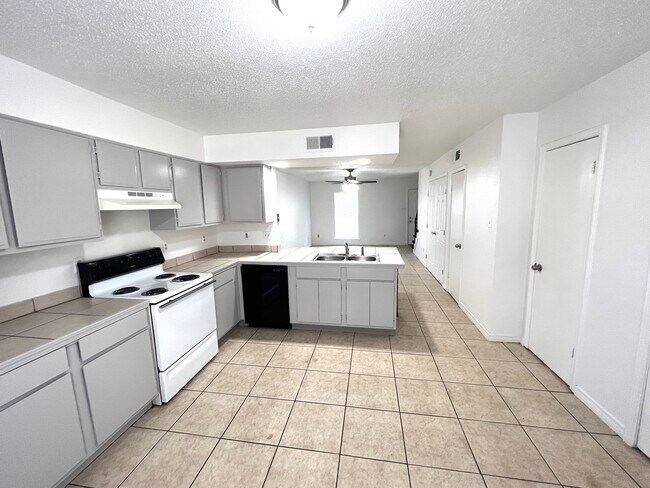 Kitchen view flows into living room - 7831 Read Blvd