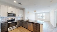 Located at 905 Lakeford Dr in Morrisville, NC, this well-designed 2-bedroom, 2-bathroom residence offers a thoughtful single-floor layout with contemporary finishes throughout. Light wood-look flooring flows seamlessly across the entire unit, creating a warm and cohesive aesthetic.

The open-concept kitchen and living area serves as the heart of the home. The kitchen features a two-tone design with white upper cabinets and gray lower cabinets, a herringbone tile backsplash, quartz countertops, stainless steel appliances including a refrigerator, range, microwave, and dishwasher, and pendant lighting over the peninsula — ideal for both cooking and entertaining.

The primary bedroom is a comfortable retreat with recessed lighting, large windows for natural light, and access to a well-organized walk-in closet with built-in shelving. Its en-suite bathroom includes a gray vanity with a white quartz countertop, a large framed mirror, and matte black fixtures. The second bedroom also features ample natural light and an outdoor view. The second bathroom offers a subway-tiled tub-shower combination, a matching gray vanity, and consistent matte black hardware. Additional conveniences include a dedicated laundry area, hallway, and two closets, rounding out this clean, modern residence.