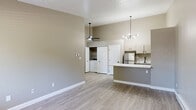 Located at 988 Muirwood Village Dr. in Columbus, OH, this one-bedroom, one-bathroom unit offers a well-designed, single-floor layout with modern updates throughout. The open-concept living area greets you at the entrance, featuring light-toned luxury vinyl plank flooring, vaulted ceilings, and a large window that fills the space with natural light. A wall-mounted HVAC unit provides convenient climate control directly in the living room. The kitchen is a standout feature, showcasing a peninsula with a striking marble-look countertop, warm taupe cabinetry, stainless steel appliances including a refrigerator and dishwasher, and a contemporary sputnik-style chandelier overhead. A dedicated laundry area with a full-size washer and dryer is conveniently tucked behind double doors adjacent to the kitchen. The bedroom is generously proportioned, offering a textured ceiling, a ceiling fan with light fixture, baseboard heating, and a window with outdoor views. The bathroom is clean and functional, featuring a full tub-shower combination with a grab bar, updated fixtures in matte black, and matching luxury vinyl plank flooring. Neutral taupe wall tones and consistent flooring materials create a cohesive, move-in-ready aesthetic throughout the entire unit.