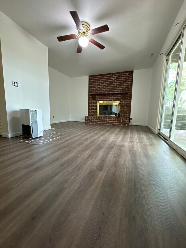 Downstairs living room, access to patio. NEW FLOORS & Paint - 2413 Ridge Rd