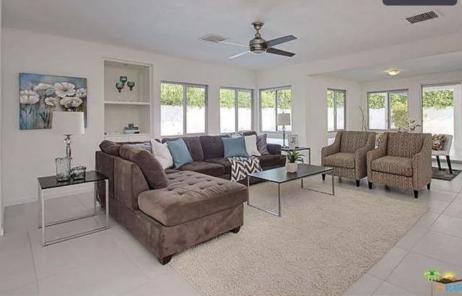 Large sunlit primary living room with ample seating and dining... - 2080 E McManus Dr