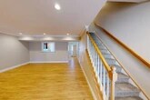 Located at 100 Pheasant's Run in Clinton, NY, this well-appointed two-story home offers three bedrooms, two full bathrooms, and a thoughtfully designed layout spread across two floors. The main level welcomes you with a spacious open-concept kitchen and living area featuring warm hardwood-style flooring, recessed lighting, and crown molding. The kitchen is outfitted with rich dark wood cabinetry, granite countertops, a tile backsplash, and a full suite of stainless steel appliances including a refrigerator, range, microwave, and dishwasher. A pass-through window connects the kitchen to the living area, enhancing the open feel of the space. A carpeted staircase with a classic wood banister and white balusters leads to the upper level, where three bedrooms await, each with plush carpet, natural light from bright windows, and generous closet space — with seven closets total throughout the home. The bathrooms are finished with dark-toned vanities, granite countertops, and tub-shower combinations. A dedicated laundry room with a washer and dryer adds everyday convenience. The home also includes an attached garage with an automatic opener, a utility room, and a hallway connecting the upper-level rooms. Neutral tones and clean finishes give the home a move-in ready feel throughout.