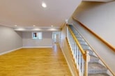 Located at 100 Pheasant's Run in Clinton, NY, this well-appointed two-story home offers three bedrooms, two full bathrooms, and a thoughtfully designed layout spread across two floors. The main level welcomes you with a spacious open-concept kitchen and living area featuring warm hardwood-style flooring, recessed lighting, and crown molding. The kitchen is outfitted with rich dark wood cabinetry, granite countertops, a tile backsplash, and a full suite of stainless steel appliances including a refrigerator, range, microwave, and dishwasher. A pass-through window connects the kitchen to the living area, enhancing the open feel of the space. A carpeted staircase with a classic wood banister and white balusters leads to the upper level, where three bedrooms await, each with plush carpet, natural light from bright windows, and generous closet space — with seven closets total throughout the home. The bathrooms are finished with dark-toned vanities, granite countertops, and tub-shower combinations. A dedicated laundry room with a washer and dryer adds everyday convenience. The home also includes an attached garage with an automatic opener, a utility room, and a hallway connecting the upper-level rooms. Neutral tones and clean finishes give the home a move-in ready feel throughout.