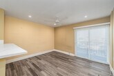 Located at 536 Linden Ave in Long Beach, California, this efficiently designed one-bedroom, one-bathroom unit offers a well-appointed layout across a single floor. The space is finished with warm, neutral-toned walls and a consistent design language throughout.

The kitchen is a standout feature, showcasing crisp white shaker cabinetry extending to the ceiling for ample storage, white quartz countertops, and a full suite of stainless steel appliances including a refrigerator, electric range, and over-the-range microwave. A peninsula with a breakfast bar overhang connects the kitchen to the living area, which features wood-look plank flooring and recessed lighting.

The bedroom offers a comfortable footprint, wood-look flooring, a ceiling fan with recessed lighting, a window for natural light, and a mirrored sliding closet door that enhances the sense of space.

The bathroom is clean and modern, featuring large-format marble-style tile flooring, a full bathtub and shower combination with a curved curtain rod, a wall-mounted vanity with a vessel-style sink, and warm neutral walls.

A hallway connects the rooms and includes tile flooring that transitions into the kitchen area. The overall ambiance is bright, clean, and move-in ready, reflecting a thoughtfully updated interior in a convenient Long Beach location.