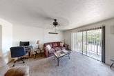 Located at 4201 Valley Forge Road in Mount Vernon, Illinois, this single-floor, one-bedroom, one-bathroom unit offers a practical and comfortable layout. The living room serves as the heart of the home, featuring soft carpeting, a ceiling fan with light fixture, and a large sliding glass door fitted with vertical blinds that opens to a balcony, allowing natural light and outdoor views to fill the space. The front entry area provides a welcoming transition into the main living area.

The kitchen is efficiently designed with dark espresso-toned cabinetry, light countertops, and wood-look vinyl plank flooring. It is equipped with a range, refrigerator, and oven, with overhead task lighting provided by a drop ceiling with integrated panels.

The bedroom is generously proportioned and features plush carpeting, a large window with vertical blinds that brings in natural light, and an expansive wall of built-in louvered closet doors with mirrored panels, providing ample storage. The textured ceiling is consistent throughout the unit.

The bathroom includes a full shower with a curtain enclosure and wood-look vinyl flooring, offering a clean and functional space. A connecting hallway ties the rooms together, completing this well-organized and practical single-level home.