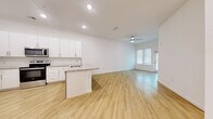 Located at 510 North Rome Avenue in Tampa's desirable Hyde Park neighborhood, this thoughtfully designed 2-bedroom, 2-bathroom residence offers a clean, modern aesthetic across a single floor. Light wood-style flooring flows seamlessly throughout the entire space, creating a warm and cohesive feel.

The open-concept living and kitchen area serves as the heart of the home. The kitchen features white shaker-style cabinetry, granite countertops, a peninsula with a built-in sink, and a full suite of stainless steel appliances including a refrigerator, electric range, and over-the-range microwave. A pantry provides additional storage. The living area is bright and airy, benefiting from a ceiling fan and a glass door that invites natural light and outdoor access.

Both bedrooms are well-proportioned, each equipped with a ceiling fan, closet storage, and windows with blinds offering natural light and privacy. The primary bedroom includes generous closet space. A dedicated laundry area and multiple hallway closets add practical storage throughout.

Each bathroom is finished consistently with granite-topped white vanities, tub-shower combinations with white tile surrounds, and wood-look flooring, maintaining the home's clean, modern character from room to room.