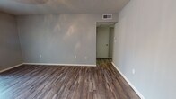 Located in Edmond, Oklahoma, this single-floor home at 3621 Wynn Dr offers a clean, updated interior with a cohesive and modern aesthetic throughout. Rich, wood-look plank flooring runs continuously across the living areas, bedrooms, and hallways, providing warmth and visual continuity. The walls are finished in soft, neutral gray tones that complement the flooring and create a calm, inviting atmosphere.

The living area is generously proportioned and features a sliding glass door dressed with vertical blinds, allowing abundant natural light to filter in while providing access to the outdoors. A ceiling fan with a light fixture adds both comfort and functionality to the space. The textured popcorn ceilings are consistent throughout the home.

The kitchen is designed with a galley-style layout, featuring gray cabinetry, speckled light countertops, and black appliances including a range and dishwasher—offering an efficient and practical cooking space.

The bedrooms are well-sized, each featuring ceiling fans, neutral walls, and ample natural light through windows with blinds. One bedroom includes convenient access to an adjoining room or hallway.

The bathroom is neatly appointed with a shower-tub combination, a vanity with matching countertop, and wood-look flooring that ties in seamlessly with the rest of the home. Overall, this residence presents a tidy, move-in ready environment with consistent finishes throughout.