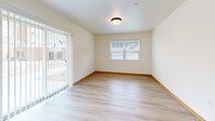 Located at 2040 Maxwell Dr in Hudson, WI, this single-floor, 2-bedroom, 1-bathroom unit offers a well-designed layout with a clean, neutral aesthetic throughout. Light wood-tone laminate flooring and warm oak-toned trim flow consistently across every room, creating a cohesive and inviting atmosphere.

The kitchen is a standout feature, offering generous counter space, light maple cabinetry, and a full suite of stainless steel appliances including a gas range, built-in microwave, refrigerator, and dishwasher. Recessed lighting and a window bring natural light into the space.

The open living area includes a wall-mounted mini-split HVAC unit and sliding glass doors with vertical blinds that lead directly to a private patio, providing easy outdoor access and natural light. A secondary window adds additional brightness to the room.

The primary bedroom is a comfortable size, featuring a ceiling fan, a large window with outdoor views, and ample closet space with bifold doors. The second bedroom is also well-proportioned with its own closet.

The bathroom is equipped with an accessible walk-in shower featuring stainless steel grab bars. Additional highlights include abundant closet storage throughout, a dedicated laundry area, and a practical hallway connecting all rooms efficiently.