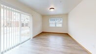 Located at 2040 Maxwell Dr in Hudson, WI, this single-floor, 2-bedroom, 1-bathroom unit offers a well-designed layout with a clean, neutral aesthetic throughout. Light wood-tone laminate flooring and warm oak-toned trim flow consistently across every room, creating a cohesive and inviting atmosphere.

The kitchen is a standout feature, offering generous counter space, light maple cabinetry, and a full suite of stainless steel appliances including a gas range, built-in microwave, refrigerator, and dishwasher. Recessed lighting and a window bring natural light into the space.

The open living area includes a wall-mounted mini-split HVAC unit and sliding glass doors with vertical blinds that lead directly to a private patio, providing easy outdoor access and natural light. A secondary window adds additional brightness to the room.

The primary bedroom is a comfortable size, featuring a ceiling fan, a large window with outdoor views, and ample closet space with bifold doors. The second bedroom is also well-proportioned with its own closet.

The bathroom is equipped with an accessible walk-in shower featuring stainless steel grab bars. Additional highlights include abundant closet storage throughout, a dedicated laundry area, and a practical hallway connecting all rooms efficiently.