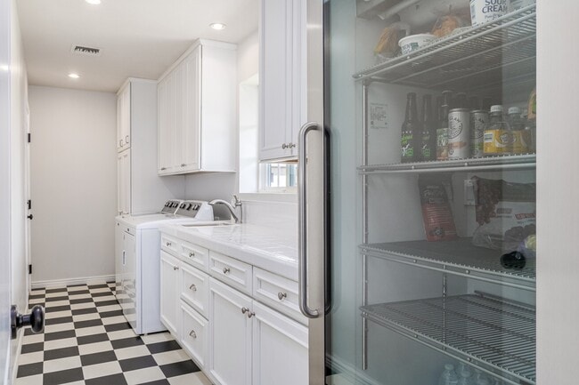 large open laundry room includes ample storage and full-size beverage cooler - 5214 N 43RD PL