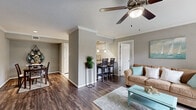 Located in Seabrook, TX, this well-appointed 2-bedroom, 2-bathroom single-story home offers a comfortable and cohesive coastal aesthetic throughout. The open living area features rich wood-look flooring, crown molding, a ceiling fan, and a sliding glass door that fills the space with natural light while providing access to an outdoor patio. The layout flows naturally into two dining areas, offering flexible use of space for everyday dining and entertaining.

The kitchen is thoughtfully updated with white shaker cabinetry, granite countertops, a classic subway tile backsplash, and stainless steel appliances, including a refrigerator and dishwasher. Light tile flooring completes the clean, bright look of this culinary space.

Both bedrooms are carpeted and include ceiling fans, with the primary bedroom offering a generous footprint and a window overlooking the exterior. The bathrooms are neatly finished with tile flooring, and one features a tub-shower combo with decorative mosaic tile accents.

Additional highlights include a dedicated laundry room with full-size washer and dryer connections, two closets for ample storage, and a hallway connecting the home's private areas. The consistent warm-gray wall palette and coastal decor touches lend the home a relaxed, inviting character throughout.