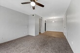 This single-floor, 2-bedroom, 2-bathroom residence in Birmingham, Alabama presents a functional and well-organized layout. The living room is a comfortable, carpeted space featuring a ceiling fan and sliding glass doors with vertical blinds that invite natural light and provide outdoor views. An adjoining dining area connects seamlessly to the kitchen, which is equipped with white cabinetry, light countertops, a double stainless steel sink, and black appliances including a refrigerator and dishwasher. A dedicated pantry with open shelving offers additional storage convenience. Both bedrooms are carpeted and receive natural light through windows with outdoor views. Each bedroom includes closet space, with one bedroom featuring a built-in closet and access to a bathroom. The two bathrooms are clean and bright, with one featuring a wide vanity, white cabinetry, and a well-lit mirror. Throughout the home, wood-look flooring appears in the kitchen and bathroom areas, while carpet covers the living and bedroom spaces. A hallway connects the rooms efficiently, and a dedicated laundry area and utility room add everyday practicality. Textured ceilings are consistent throughout the residence.
