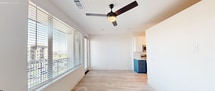 This contemporary 510 square foot apartment maximizes space efficiency in its one-bedroom layout. The heart of the home is a sleek, galley-style kitchen featuring two-tone cabinetry in white and blue, complemented by stainless steel appliances and quartz countertops. The kitchen seamlessly flows into a bright living area with light wood-look flooring and large windows that flood the space with natural light and offer city views.

The bedroom, measuring 100 square feet, includes a ceiling fan and continues the light, airy feel with its neutral color palette and plush carpeting. An en-suite bathroom showcases modern design with a hexagonal tile floor, white vanity, and a generous closet space.

Throughout the apartment, recessed lighting and modern fixtures enhance the contemporary ambiance. The unit's single floor plan is thoughtfully designed to maximize functionality and style, making it an ideal urban dwelling. High ceilings and an open concept contribute to a sense of spaciousness, while careful attention to detail in finishes and fixtures elevates the overall aesthetic of this compact yet sophisticated living space.