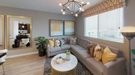 Located at 1660 Metro Ave in Chula Vista, this model residence showcases a refined modern aesthetic across a well-appointed single-floor layout. Light wood-style flooring flows throughout the main living areas, creating a warm, cohesive foundation for the contemporary design.

The open kitchen is a standout feature, outfitted with rich dark wood cabinetry, crisp white quartz countertops, and a classic subway tile backsplash. Stainless steel appliances, including a gas range, built-in microwave, and French door refrigerator, complete the space, while a pendant light adds a curated finishing touch.

The dining area accommodates generous seating around a substantial dark wood table, accented by a statement artwork near the entry. The living room offers a comfortable, stylish retreat with a sectional sofa, bold geometric chandelier, and natural light from large windows with outdoor views.

The bedroom is elegantly appointed with a distinctive patterned feature wall, soft carpeting, and windows on multiple sides that bring in ample natural light. The bathroom continues the cohesive design with dark wood cabinetry, white countertops, and wood-look flooring. Throughout the residence, a warm gold, gray, and white palette ties each space together seamlessly.