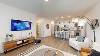 Located at 6857 Poetry Pl in Greenfield, Indiana, this single-story home offers four bedrooms and two bathrooms across a well-designed floor plan. The open-concept living and kitchen area forms the heart of the home, featuring light wood-look flooring, recessed lighting, and a bright, airy atmosphere. The kitchen is appointed with white cabinetry, granite countertops, stainless steel appliances, and a large center island with bar seating — ideal for both cooking and casual dining. The living area provides generous space for relaxation, with access to an outdoor area through a glass door that invites natural light. The central hallway connects all four bedrooms, each carpeted for comfort and featuring windows that bring in natural light. The primary bedroom offers a comfortable, well-proportioned retreat with a ceiling fan. The additional bedrooms are versatile, suitable for sleeping, working, or other uses. Two full bathrooms serve the home, each featuring a tub-shower combination and granite vanity surfaces. A dedicated laundry room with full-size washer and dryer hookups adds everyday convenience. The home's clean white walls, consistent flooring, and modern fixtures create a cohesive, move-in-ready feel throughout.