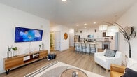 Located at 6857 Poetry Pl in Greenfield, Indiana, this single-story home offers four bedrooms and two bathrooms across a well-designed floor plan. The open-concept living and kitchen area forms the heart of the home, featuring light wood-look flooring, recessed lighting, and a bright, airy atmosphere. The kitchen is appointed with white cabinetry, granite countertops, stainless steel appliances, and a large center island with bar seating — ideal for both cooking and casual dining. The living area provides generous space for relaxation, with access to an outdoor area through a glass door that invites natural light. The central hallway connects all four bedrooms, each carpeted for comfort and featuring windows that bring in natural light. The primary bedroom offers a comfortable, well-proportioned retreat with a ceiling fan. The additional bedrooms are versatile, suitable for sleeping, working, or other uses. Two full bathrooms serve the home, each featuring a tub-shower combination and granite vanity surfaces. A dedicated laundry room with full-size washer and dryer hookups adds everyday convenience. The home's clean white walls, consistent flooring, and modern fixtures create a cohesive, move-in-ready feel throughout.