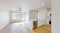 Located on Dry Creek Drive in Longmont, Colorado, this two-bedroom, two-bathroom single-floor residence offers a clean, modern design with an open and airy feel. Light wood-tone flooring flows consistently throughout, unifying each space with warmth and continuity.

The open-concept kitchen and living area serves as the heart of the home. The kitchen is appointed with crisp white shaker cabinetry, a full suite of stainless steel appliances including a refrigerator with ice maker, range, microwave, and dishwasher, and a generous island with a quartz countertop, undermount sink, and stylish pendant lighting overhead. The adjoining living area benefits from abundant natural light streaming through large windows and a glass-paneled entry door, with a ceiling fan adding comfort.

Both bedrooms are well-proportioned, featuring ceiling fans, large windows with blinds—one offering views of the surrounding Longmont landscape and distant mountains—and easy access to closet space. The primary bedroom includes a dedicated closet with built-in shelving.

The two bathrooms are finished in a consistent white palette, with white shaker vanities and tile surround tub-shower combinations. Clean lines and neutral tones define the overall aesthetic, making this a bright, move-in-ready residence with a fresh, contemporary character.