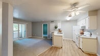 Located at 3825 Little Rock Drive in Antelope, California, this single-story, three-bedroom, two-bathroom home offers a well-organized and functional floor plan. The layout flows from a welcoming entrance through a spacious living area featuring neutral carpet and wood-look flooring, with a ceiling fan adding comfort overhead.

The galley-style kitchen is equipped with white cabinetry, light stone-finish countertops, a double sink, and white appliances including a range and refrigerator. A peninsula counter opens the kitchen toward the living area, creating an accessible and connected feel throughout the common spaces.

Three carpeted bedrooms provide comfortable retreats, each finished in soft gray tones with natural light filtering through windows offering views of surrounding greenery. The primary bedroom offers a generous footprint suitable for a full furniture arrangement.

Both bathrooms are finished with wood-look vinyl flooring, white vanities with stone-finish countertops, and full tub-shower combinations with curtain enclosures. A dedicated laundry room houses a full-size top-loading washer and dryer with overhead shelving for added storage. A hallway and closet round out the interior, contributing to the home's practical and efficient use of space throughout.