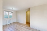 Located at 708 Gilbert St in the charming neighborhood of Takoma Park, Maryland, this one-bedroom, one-bathroom residence offers a thoughtfully arranged single-floor layout. Light wood-tone flooring runs throughout, creating a clean and cohesive aesthetic across all rooms.

The combined living and dining area serves as the heart of the home, featuring a classic chandelier overhead, a wall-mounted radiator, and a bright window that draws in natural light and offers views of the surrounding greenery. An arched passageway connects this open space to the rest of the unit, adding a subtle architectural character. Two doors in the living area provide entry access alongside additional closet storage.

The bedroom is a comfortable, well-lit retreat with its own window, a radiator for warmth, and light-filled walls that enhance the sense of openness. Three closets throughout the unit offer generous storage options.

The kitchen is equipped with warm honey-toned wood cabinetry, dark granite-style countertops, a stainless steel sink, and a classic white subway tile backsplash. A window above the counter brings in natural light, while a white range completes the functional cooking space.

The bathroom features a full soaking tub framed by clean white subway tile surrounds and chrome fixtures, maintaining the home's consistent, bright aesthetic. A hallway connects the rooms with ease, rounding out this efficient and welcoming residence.