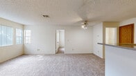 This single-floor, 2-bedroom, 2-bathroom unit in Vallejo, CA (94591) offers a practical and efficiently designed layout. The combined living room and kitchen serves as the central hub of the home, where warm wood-toned cabinetry, a stainless steel refrigerator, and a peninsula counter define the kitchen space. A ceiling fan overhead and carpet underfoot give the living area a comfortable, functional character, with textured popcorn ceilings present throughout.

The primary bedroom is a well-proportioned space featuring carpet flooring, natural light from windows with vertical blinds, and access to a dedicated walk-in closet equipped with built-in hanging rods. The second bedroom also features carpet, multiple windows that invite abundant natural light, and a standard closet with built-in shelving.

Both bathrooms are cleanly appointed. One features a vanity with wood cabinetry, a wall-mounted mirror, and a shower stall with sliding glass doors, while the second includes a tub/shower combination with a sliding glass enclosure. Tile flooring is present in both bathrooms. Overall, the unit offers a straightforward, livable layout suited for everyday comfort.