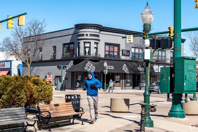A jogger running past local shops and through downtown Plymouth