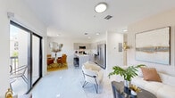 Located in Hialeah, FL, this well-appointed 2-bedroom, 2-bathroom unit offers a thoughtfully designed open-concept layout across a single floor. The living, dining, and kitchen areas flow seamlessly together, unified by gleaming large-format polished tile flooring and bright white walls that amplify the sense of space and light throughout.

The kitchen is a standout feature, equipped with stainless steel appliances, ample gray cabinetry, clean white countertops, and a central island with bar seating — ideal for casual dining or entertaining. The adjacent dining area benefits from a large grid-pane window that draws in natural light, while the living room opens to one of two private balconies via sliding glass doors, offering outdoor views of the surrounding greenery.

The primary bedroom is a comfortable retreat with warm neutral tones, a sliding glass door to a private balcony with outdoor views, and generous closet space. The second bedroom features cool blue tones and a bright window with garden views. Both bathrooms are finished with marble-style tile, modern vanities, and clean contemporary fixtures.

With five closets throughout, a dedicated hallway, and a cohesive modern aesthetic, this unit delivers practical functionality alongside a polished, move-in-ready appeal in the heart of Hialeah.