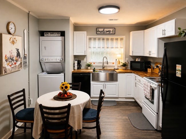 Fully furnished kitchen with full-size appliances, dining space, and private in-unit washer/dryer - 1115 Henrietta Dr