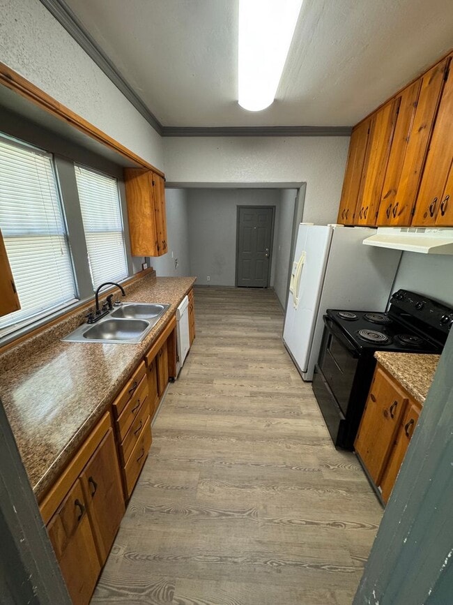 Building Photo - Three bedroom two bath home with central heat and air, large fenced backyard, and carport!