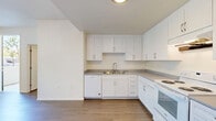 This contemporary apartment offers 810 square feet of thoughtfully designed living space. The single-floor layout comprises three bedrooms, including a primary bedroom of 120 square feet, and two full bathrooms. The heart of the home is an open-concept living area that seamlessly integrates the kitchen, dining, and living spaces. The kitchen boasts white cabinetry, a full suite of appliances, and ample counter space, perfect for culinary enthusiasts. Throughout the apartment, large windows with vertical blinds allow natural light to flood the rooms, creating a bright and airy atmosphere. The bathrooms feature modern fixtures, including a shower/tub combination and single vanities. Warm wood-look flooring unifies the space, adding a touch of elegance and easy maintenance. Built-in closets in the bedrooms provide generous storage options. The neutral color palette and clean lines contribute to the apartment's modern aesthetic, offering a blank canvas for personal style. Located at 2299 E 99th Pl in Los Angeles, this apartment combines functionality with contemporary design, ideal for those seeking a stylish urban living experience.