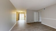 Located at 1680 Herman Dr in Gastonia, NC, this single-story home offers a thoughtfully updated interior designed for comfortable living. Wood-look flooring flows consistently throughout the main living spaces, complemented by neutral gray tones and crisp white trim that create a clean, cohesive aesthetic.

The open living area is generously proportioned, with a sliding glass door that invites natural light and provides views of the outdoors. A stylish pendant light fixture adds a touch of elegance to the adjacent dining area. A closet with bi-fold doors provides convenient built-in storage within the main living space.

The kitchen is well-appointed with white shaker-style cabinetry, light stone countertops, a stainless steel sink, and black appliances including a dishwasher and range. Light wood-look flooring and a flush-mount ceiling light complete the functional and attractive kitchen space.

The bedrooms are spacious and bright, each featuring wood-look flooring, neutral walls, and windows that allow natural light to filter in. At least one bedroom includes a reach-in closet with built-in shelving. The bathroom is equipped with a vanity featuring stone countertops, a toilet, and a full tub/shower combination, all finished with light, coordinating materials throughout.