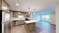 This well-appointed 2-bedroom, 2-bathroom residence in Little Canada, Minnesota offers a thoughtfully designed single-level layout that balances modern style with everyday functionality. The open-concept kitchen and living area serves as the heart of the home, featuring light wood-look flooring, recessed lighting, and a central island with a crisp white countertop and pendant lighting above. The kitchen is fully equipped with stainless steel appliances—including a refrigerator, range, microwave, and dishwasher—complemented by warm-toned cabinetry that extends to the ceiling for generous storage. Both bedrooms are carpeted for comfort and include ceiling fans, ample closet access, and large windows dressed with vertical blinds that invite natural light and views of surrounding greenery. The primary bedroom offers a dedicated closet and direct access to its own bathroom. The bathrooms are finished with wood-look tile flooring, light wood cabinetry, white countertops, and clean, neutral fixtures. A dedicated closet provides additional storage. Throughout the residence, the neutral color palette and consistent finishes create a cohesive, modern ambiance well-suited to comfortable living.