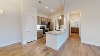 Located at 418 Battery Park Circle in Pendleton, South Carolina, this single-story, one-bedroom, one-bathroom residence offers a thoughtfully designed layout across a comfortable footprint. The open-concept living, dining, and kitchen area serves as the heart of the home, anchored by wood-look plank flooring that flows throughout the main spaces. The kitchen is well-equipped with stainless steel appliances, including an electric range, microwave, refrigerator, and dishwasher. Warm-toned cabinetry pairs with granite countertops, and a peninsula with pendant lighting provides additional workspace and a casual dining option. Recessed lighting illuminates the kitchen, while a dedicated utility room just off the kitchen houses an in-unit washer.

The living room is bright and airy, benefiting from multiple windows and a glass-paned door that invite natural light and outdoor views of the surrounding greenery. A ceiling fan adds comfort to this space. The bedroom, finished with plush carpet, also features a ceiling fan, a closet, and a window. The full bathroom is clean and modern, offering a tub-shower combination, wood-look flooring, a granite-topped vanity, and wood-toned cabinetry consistent with the rest of the unit's design aesthetic.