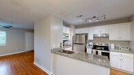This two-story home in Aiken, South Carolina offers a well-organized layout spread across two floors. The main level features an open-concept living area with warm hardwood flooring, neutral-toned walls, and a ceiling fan with light fixture that enhances the bright, airy atmosphere. The kitchen is a standout, boasting granite countertops, crisp white cabinetry with ample storage, stainless steel appliances including a refrigerator and electric range, and a peninsula with a undermount sink — ideal for both cooking and casual dining.

The upper level houses the two bedrooms, each finished with hardwood-style flooring, ceiling fans, and generous closet space. The primary bedroom includes multiple closets and direct access to additional rooms. All three bathrooms are appointed with granite-topped vanities and clean, neutral finishes; at least one bathroom features a walk-in shower.

Throughout the home, consistent use of light gray walls, white trim, and wood-tone flooring creates a cohesive and inviting aesthetic. Multiple closets across both floors provide excellent storage. The overall design is functional and well-maintained, making this Aiken home a comfortable and practical two-level residence.