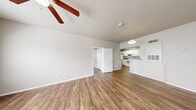 Located at 335 Cypress Creek Rd in Cedar Park, TX, this single-floor residence offers a practical and well-organized layout across two bedrooms and two full bathrooms. Wood-look flooring runs throughout the home, providing a cohesive and easy-to-maintain finish. The kitchen is equipped with white cabinetry, granite-style laminate countertops, a double-basin stainless steel sink, a dishwasher, electric range, and an over-the-range microwave, all illuminated by a skylight overhead. The combined kitchen and living area creates an open, functional hub for daily living. Both bedrooms are comfortably sized, each featuring ceiling fans, neutral-toned walls, and windows with blinds that bring in natural light. The primary bedroom is generously proportioned and includes access to a spacious walk-in closet outfitted with dual wire shelving systems on wood-look flooring. The bathrooms feature tub-shower combinations with clean white surrounds, complemented by matching cabinetry and granite-style countertops. A dedicated laundry room houses a full-size washer and dryer with overhead wire shelving and a window for natural light. The overall ambiance is clean, bright, and move-in ready.