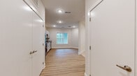 Located at 405 South 4th Street in Nashville's vibrant East Side neighborhood, this efficiently designed single-floor unit offers a clean, modern aesthetic throughout. Light-toned luxury vinyl plank flooring runs through the main living and kitchen areas, complementing the crisp white walls and recessed lighting that keep the space feeling bright and open.

The kitchen is a standout feature, outfitted with white shaker-style cabinetry, granite countertops, a stainless steel refrigerator, range, microwave, and dishwasher. A window above the sink and adjacent living area fills the space with natural light and provides a view of the surrounding greenery. The open layout between the kitchen and living area maximizes the sense of space and allows for flexible furniture arrangements.

The bedroom is a quiet, well-contained room finished with soft carpeting, neutral walls, and recessed lighting, providing a comfortable retreat. The full bathroom features wood-toned shaker cabinetry, a granite vanity countertop, a large mirror, and light hardwood-style flooring, maintaining the consistent modern finish found throughout the unit. Clean lines, updated finishes, and a thoughtful layout make this unit a practical and attractive option in one of Nashville's most dynamic neighborhoods.