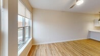 This contemporary 1-bedroom apartment in Cedar Rapids offers 1110 square feet of thoughtfully designed living space. The open floor plan seamlessly integrates the kitchen, living, and dining areas, creating a spacious and airy atmosphere. The kitchen stands out with its sleek white cabinetry, stainless steel appliances, and a convenient breakfast bar, perfect for casual dining or entertaining.

The bedroom, measuring 130 square feet, provides a cozy retreat with plush carpeting and a large window that floods the space with natural light. A modern ceiling fan adds both style and functionality. The bathroom features clean lines with a white vanity, toilet, and a tub/shower combination, complemented by warm wood-look flooring.

A standout feature is the dedicated laundry area, complete with full-sized washer and dryer units and additional storage space. Throughout the apartment, you'll find a harmonious blend of materials, including soft carpeting in the bedroom and hallway, and durable wood-look flooring in the main living areas and kitchen.

Large windows in the living room and bedroom not only brighten the space but also offer views of the surrounding area. The neutral color palette provides a blank canvas for personal decorating styles. With its efficient layout and contemporary finishes, this apartment offers a perfect balance of comfort and modern urban living.