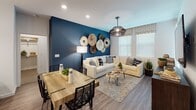 Located at 4868 Cypress St in Montclair, California, this single-floor residence showcases a thoughtfully designed interior with modern finishes and a cohesive navy and white color palette carried throughout the space. The open-concept kitchen is a standout feature, equipped with stainless steel appliances including a gas range, microwave, and refrigerator, complemented by crisp white shaker cabinetry, a grey subway tile backsplash, and a quartz-topped island with seating for multiple guests. Pendant lighting adds an elegant touch above the island. Wood-look flooring flows seamlessly from the kitchen into the dining and living area, where a bold navy accent wall serves as a dramatic backdrop. The living room benefits from natural light through large windows and features recessed lighting overhead. Two well-appointed bedrooms continue the navy accent wall theme, each offering plush carpeting, generous natural light, and mirrored closet doors for added depth. Both bathrooms are finished with white vanities, quartz countertops, full soaking tub and shower combinations, and wood-look tile flooring. The overall ambiance is contemporary and welcoming, with consistent design details that create a polished, cohesive living environment.